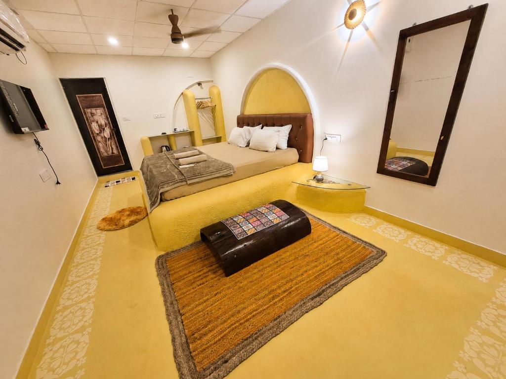 a hotel room with a bed and a mirror at Mayura sea view in Malpe