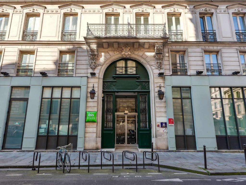 a building with a green door on a street at ibis Styles Paris République Le Marais in Paris