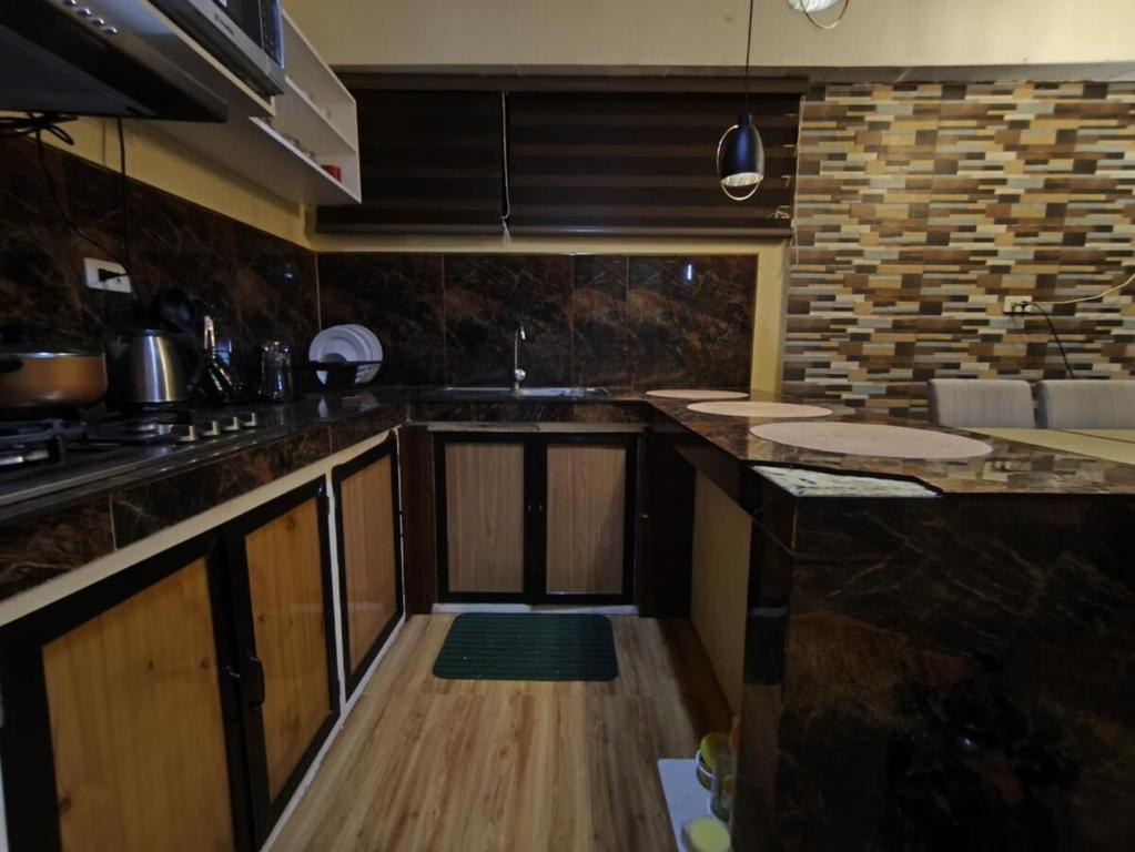 a kitchen with a sink and a counter top at Nonoy's Haven in Dipolog