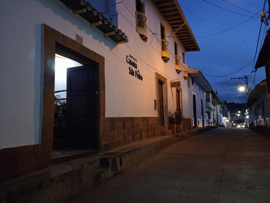 a building with a door on the side of a street at Hotel Casona de San Pedro in Curití