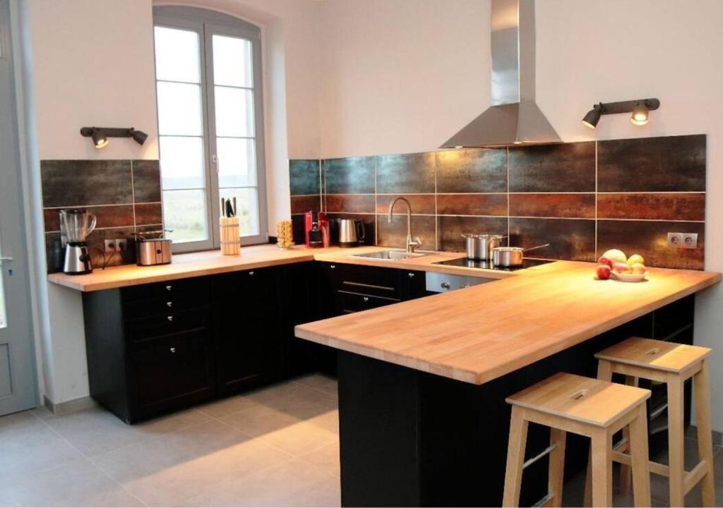 a kitchen with a wooden counter top and a sink at 6-Personen-Fewo in Buchholz
