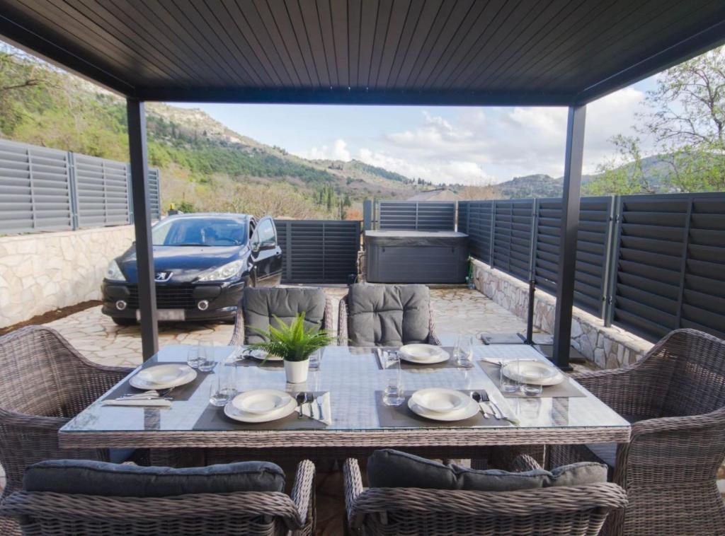 a table on a patio with a car in the background at Villa Marija Zaton in Dubrovnik