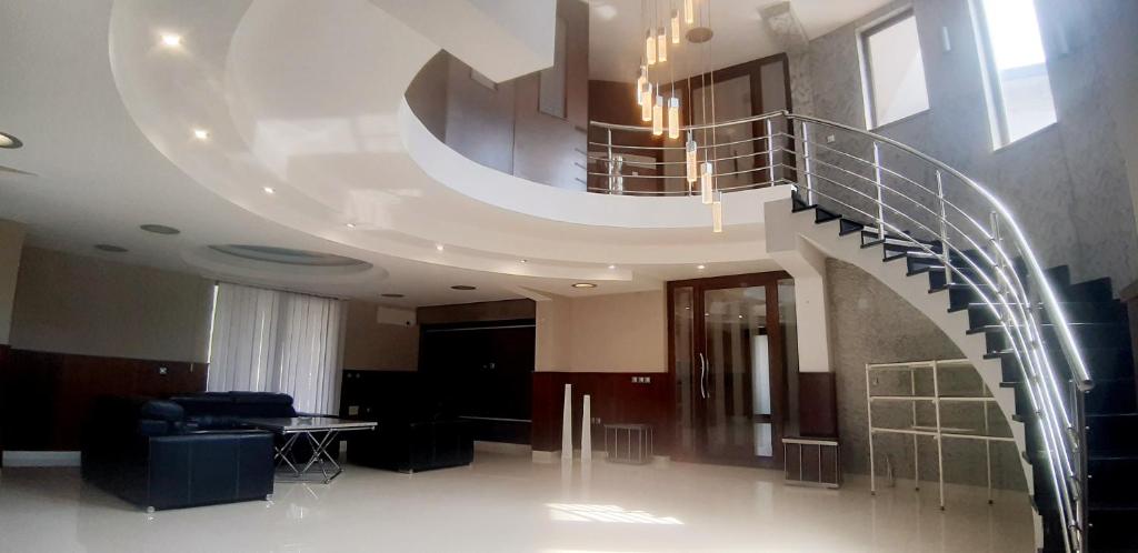 a spiral staircase in a building with a table at Holiday Home in Gevgelija