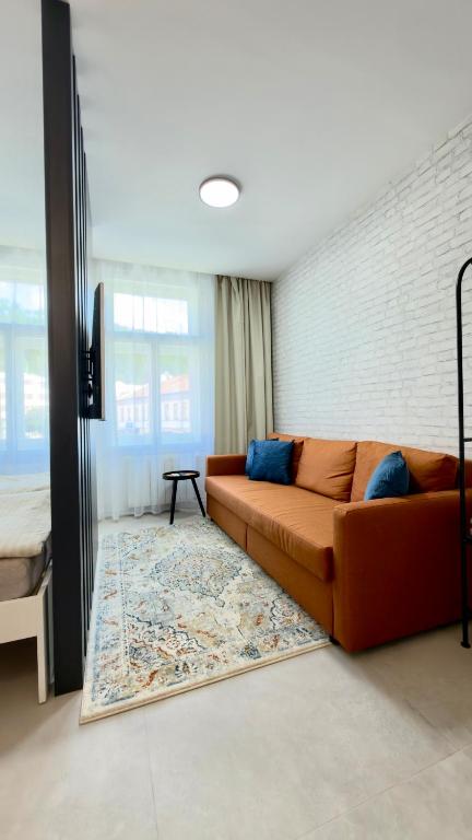 a living room with a couch and a rug at Apartmán Vita Smart in Trenčín