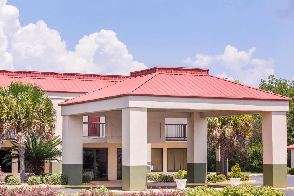 a rendering of a house with a red roof at Days Inn by Wyndham Dublin GA in Dublin