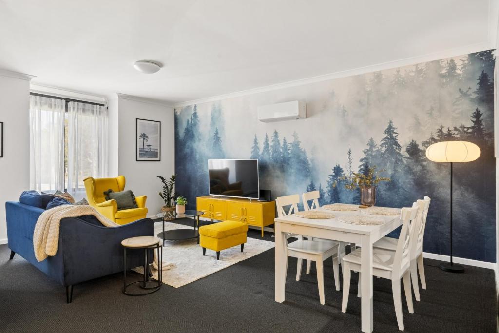 a living room with a table and a dining room at OPTUS Stadium 2BR CBD Apartment with FREE Parking in Perth
