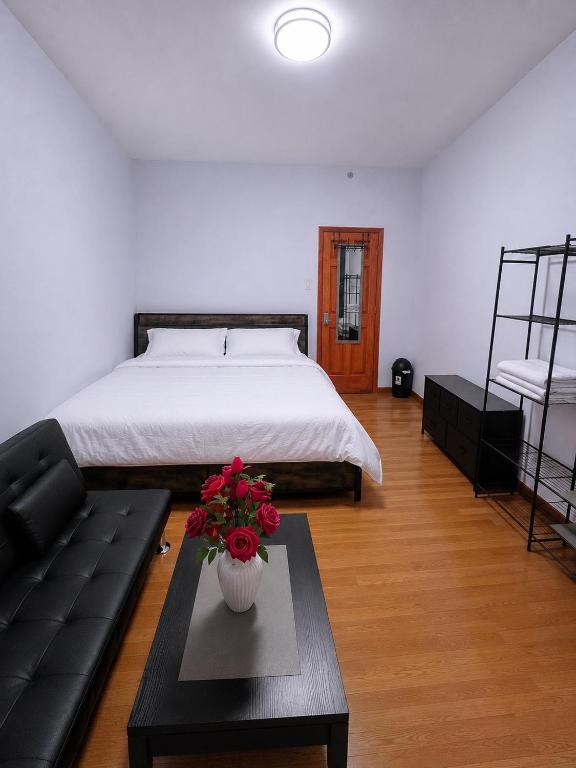a bedroom with a bed and a table with flowers on it at Amazing private Room in Glendale