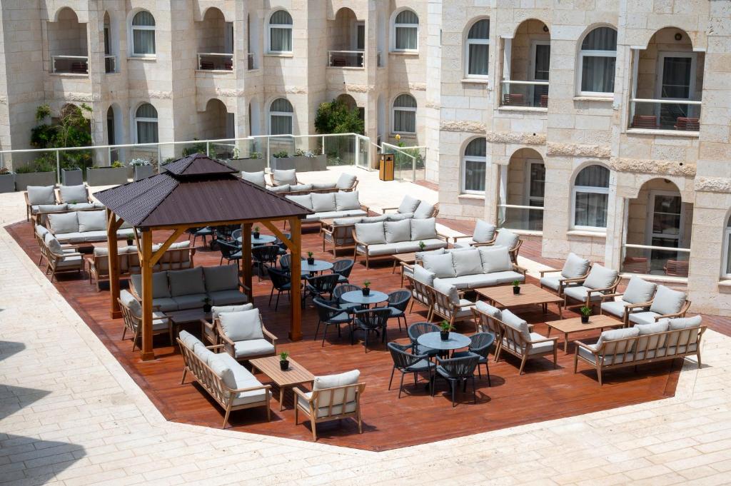 a group of chairs and tables on a patio at Naveh Tamar - Mehadrin Kosher suitable for Ultra-Orthodox guests in Acre