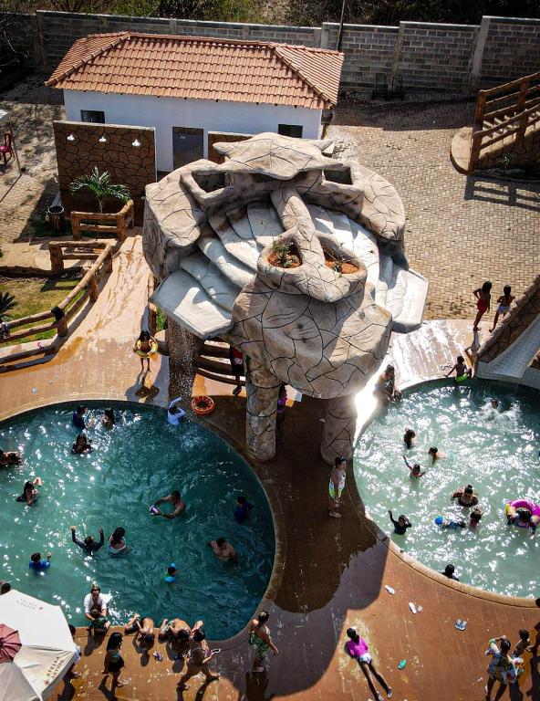 a group of people swimming in two pools at Hotel Fazenda Haras Paraíso do Atlântico in Irecê