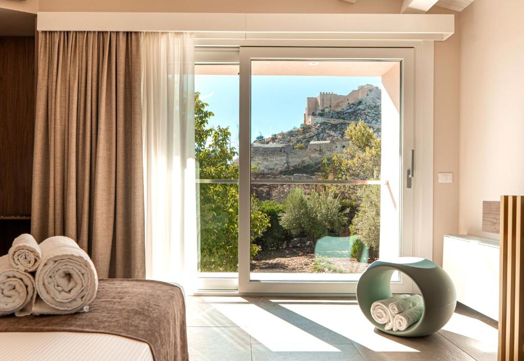 a bedroom with a large window with a mountain view at Manfredomus in Mussomeli