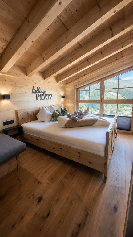a bedroom with a large bed in a log cabin at Wieslhütte in Gerlosberg