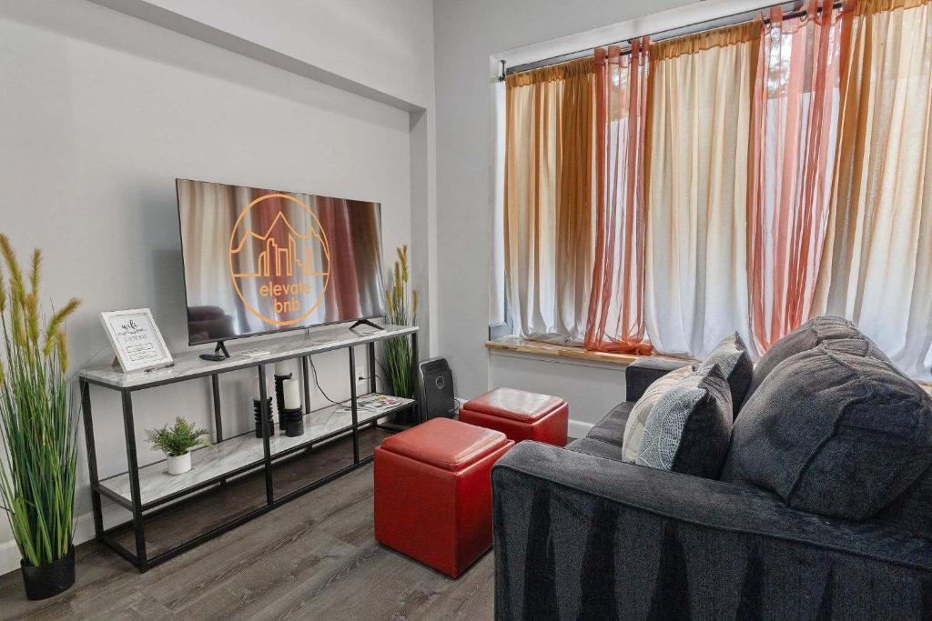 a living room with a couch and a tv at Bright loft in Wheat Ridge in Wheat Ridge