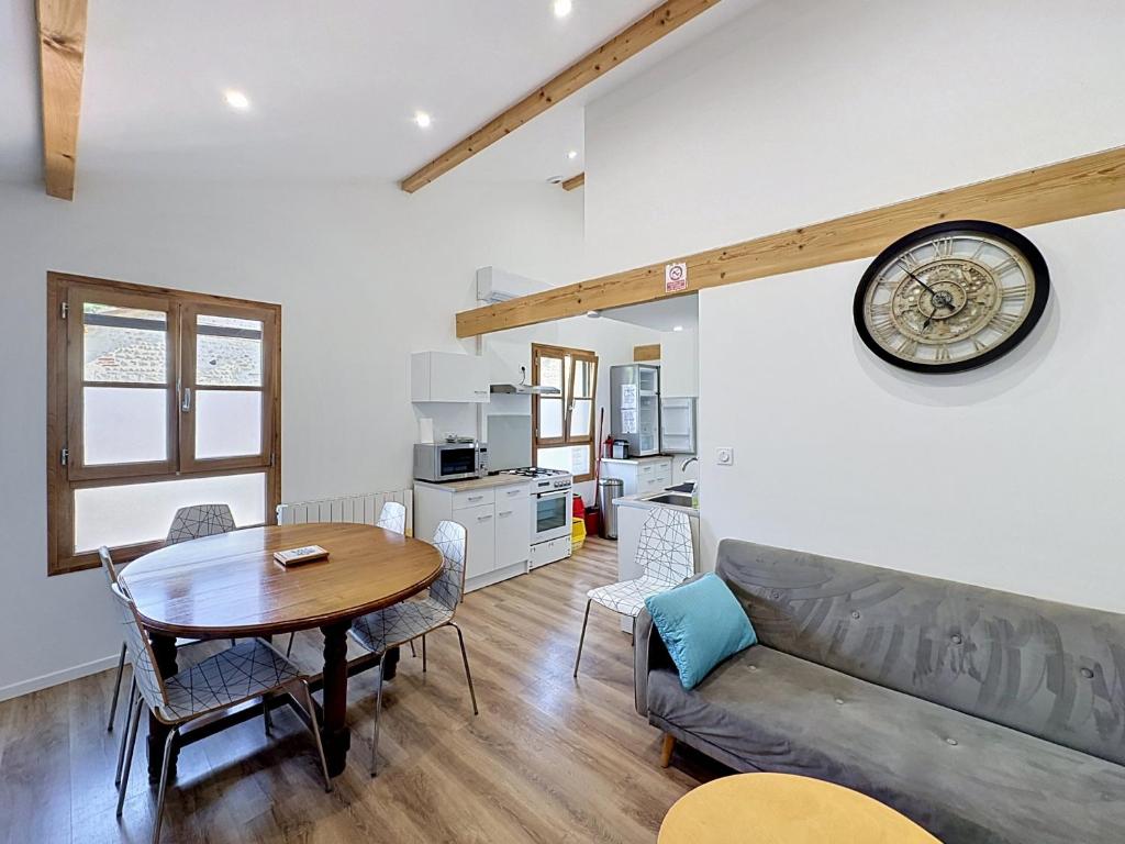 ein Wohnzimmer mit einem Tisch und einem Sofa in der Unterkunft Le Peage de Perouges in Pérouges