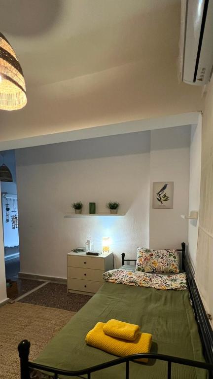 a bedroom with a bed and a table with towels on it at Azure & Zest Suites in Ierissos