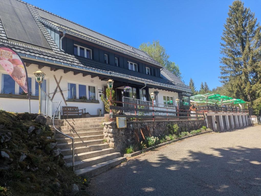 a building with a staircase in front of a house at Klosterweiherhof in Dachsberg im Schwarzwald