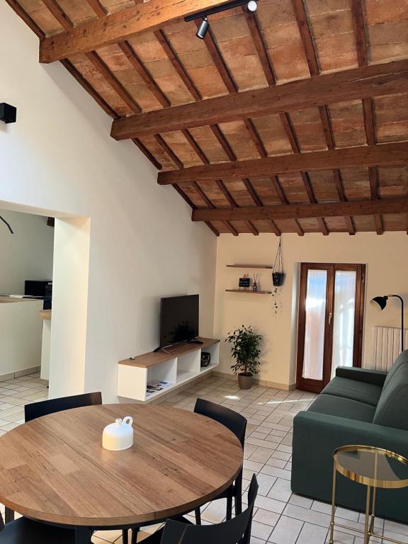 ein Wohnzimmer mit einem Holztisch und einem grünen Sofa in der Unterkunft viamarsala in Iesi