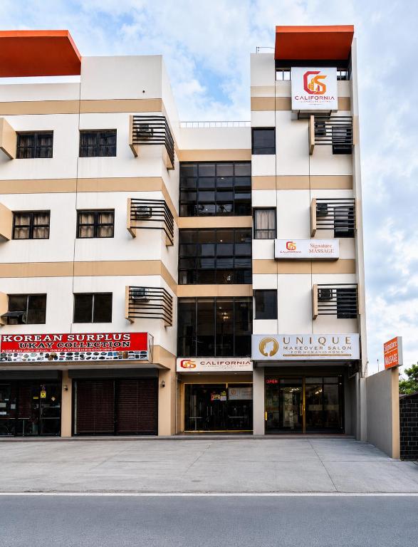 a large white building with a sign on it at California Signature Suites in Sudtungan