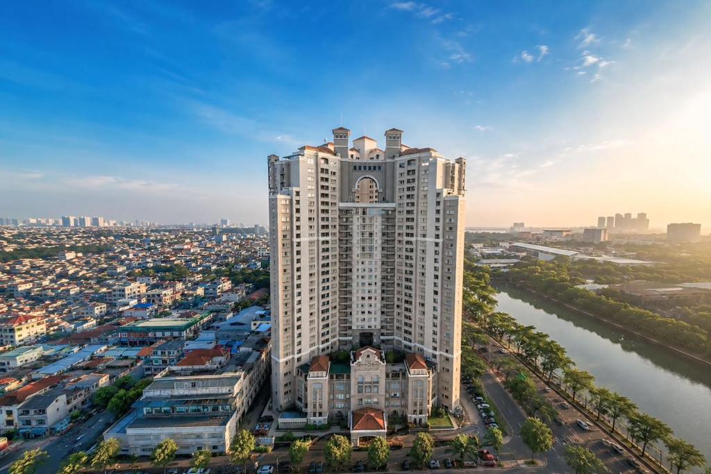 an aerial view of a tall building with a clock tower at Grand Dafam Ancol Jakarta in Jakarta