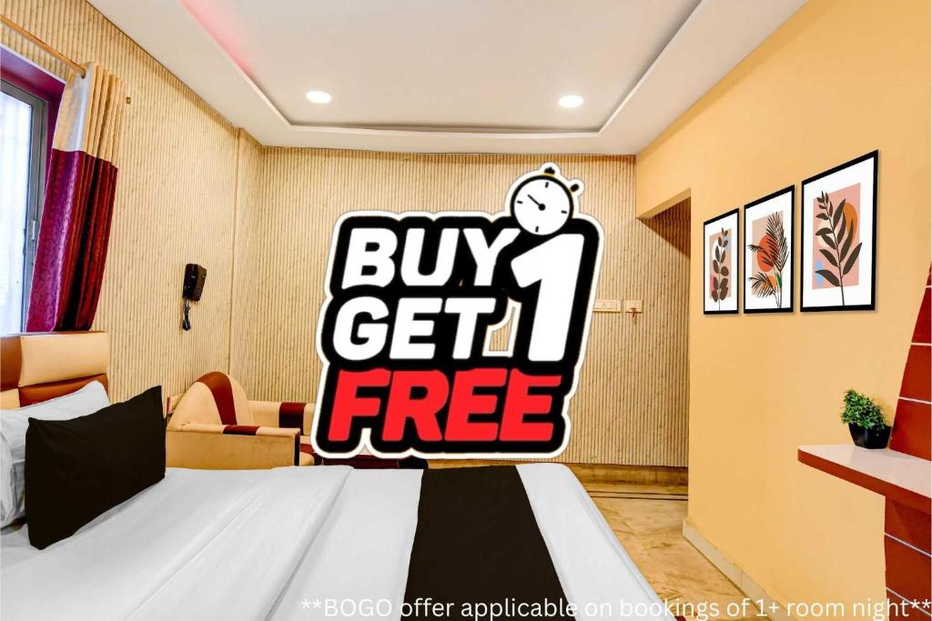 a bedroom with a bed with a buy get free sign at Super Collection O Rajarhat Formerly Redstone in Kolkata