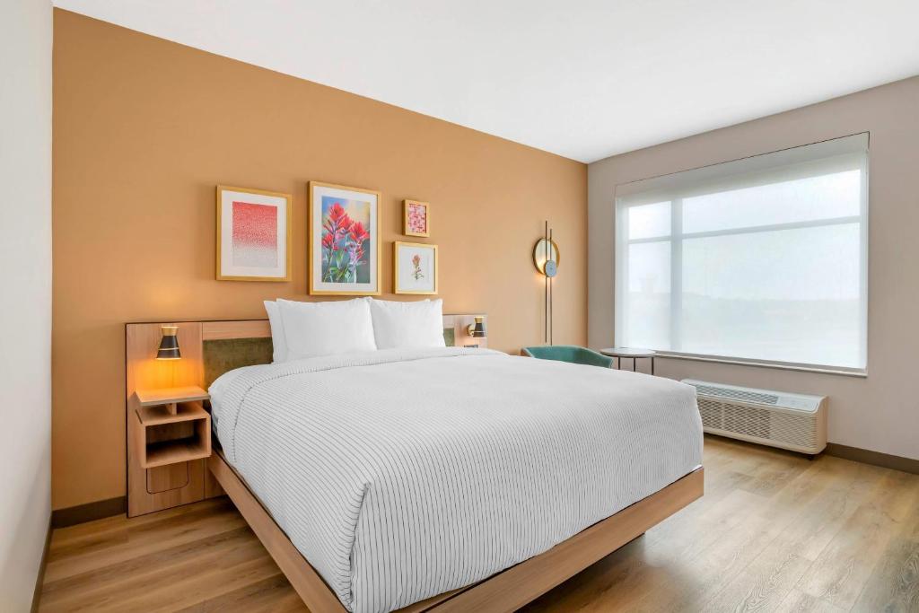 a bedroom with a large bed and a window at Cambria Hotel Euless - DFW Airport South in Euless