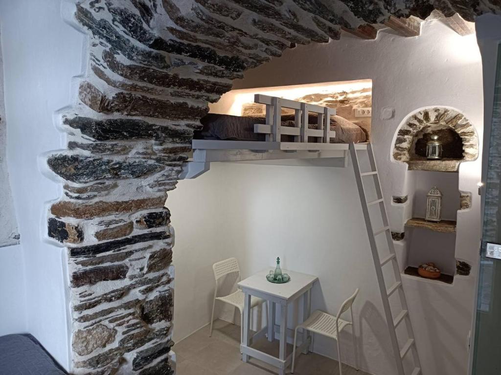 a room with a bunk bed in a brick wall at Μαγαζάκι in Tripótamos