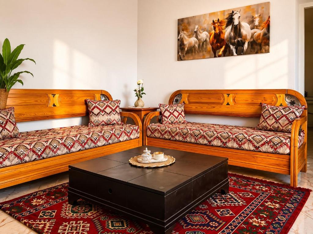 a living room with two couches and a coffee table at Cozy Retreat in Bou Ficha