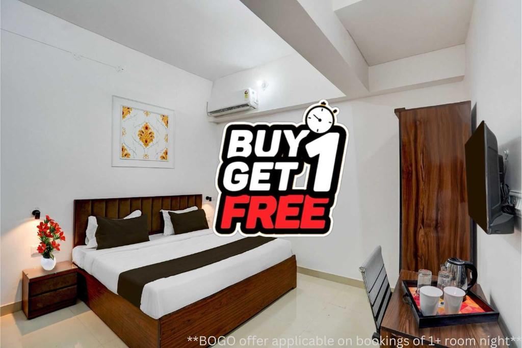 a bedroom with a bed with a buy get free sign at Super OYO Collection O Prayag Railway Junction in Colonelganj