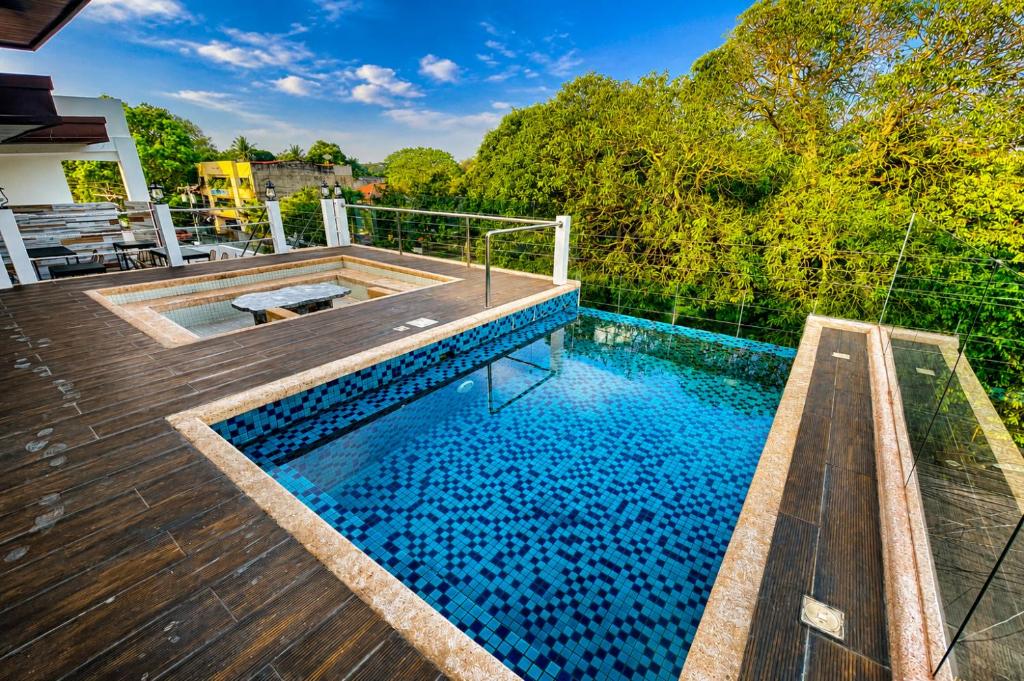 a swimming pool on the deck of a house at Lighthouse Point Hotel in Dumaguete
