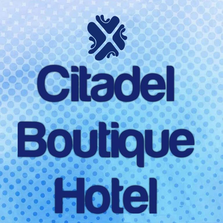 a sign with the chicago bonfirehoke hotel with a ball at Citadel Boutique Hotel in Amman
