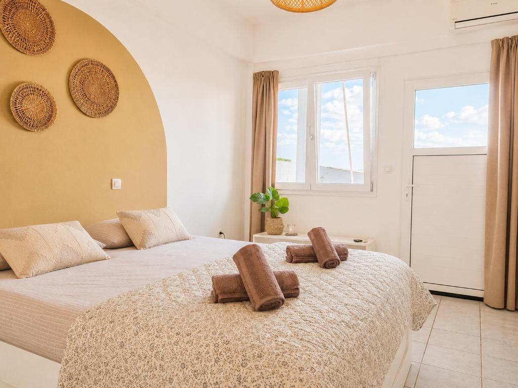 a bedroom with two beds with brown towels on them at Tolo at sea - Nova in Tolo