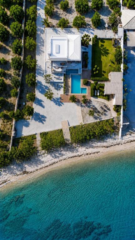 an aerial view of a house next to the water at Villa Pelagos in Koutsounari