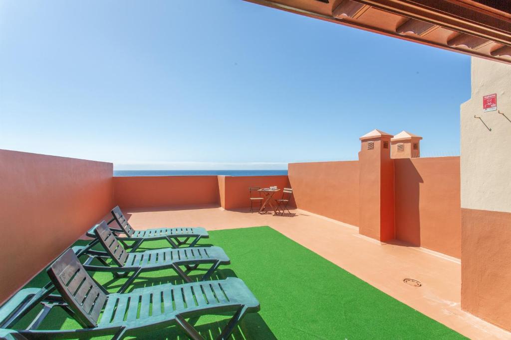 a room with chairs on the roof of a building at Ático en Candelaria 1 in Candelaria