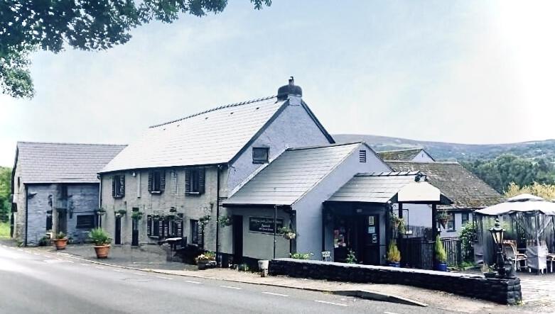 a large white building on the side of a street at Roadhouse Llanwenarth in Abergavenny