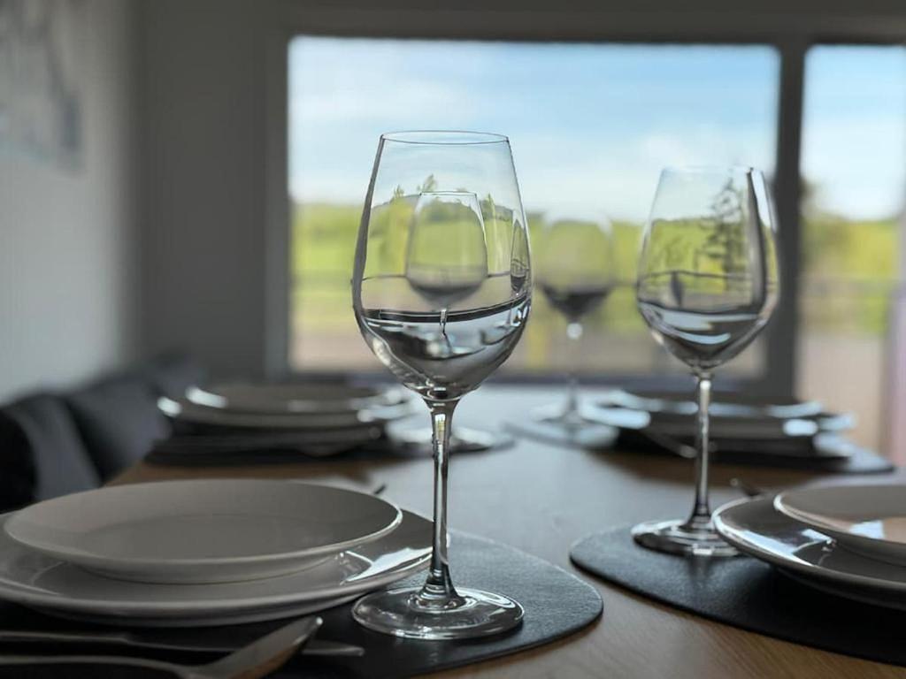 two wine glasses sitting on top of a table at Ferienwohnung BEST VIEW Brilon in Brilon