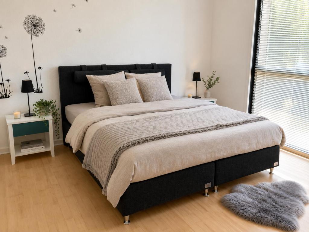 a bedroom with a large bed and a window at Stor 2 værelses lejlighed in Randers