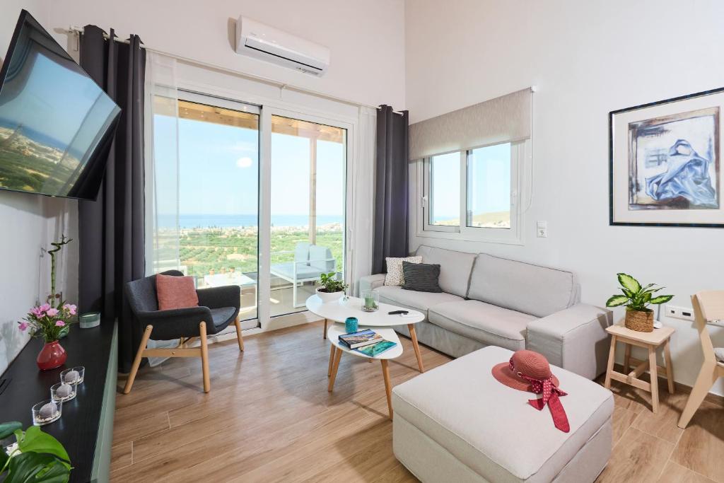 a living room with a couch and a tv at Gaea Loft Villa - 1st Floor in Kokkini Khanion