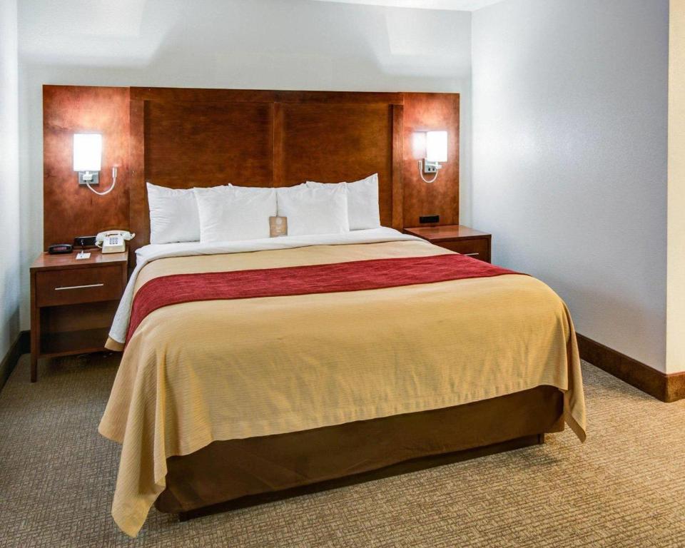 a hotel room with a large bed with two night stands at Comfort Inn Redding Near I-5 in Redding