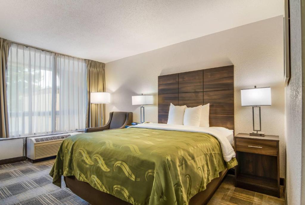 a hotel room with a bed and a window at Quality Inn Suwanee I-85 in Suwanee