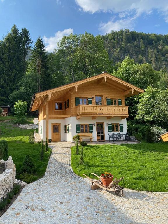 a house with a bike parked in front of it at Chalet Vogelnest am Waldbach in Reit im Winkl