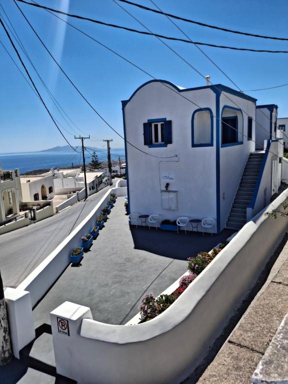 a house with stairs on the side of a street at Villa Firostefani in Firostefani