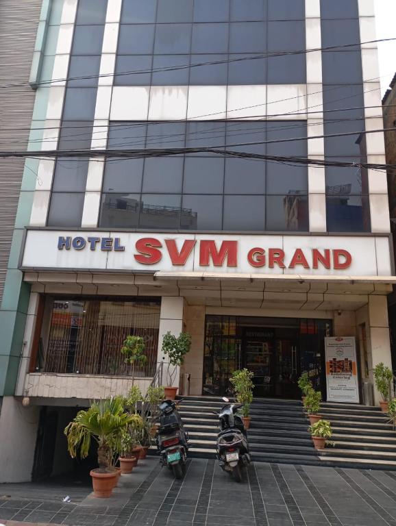 two motorcycles parked in front of a building at Hotel SVM Grand Koti in Hyderabad