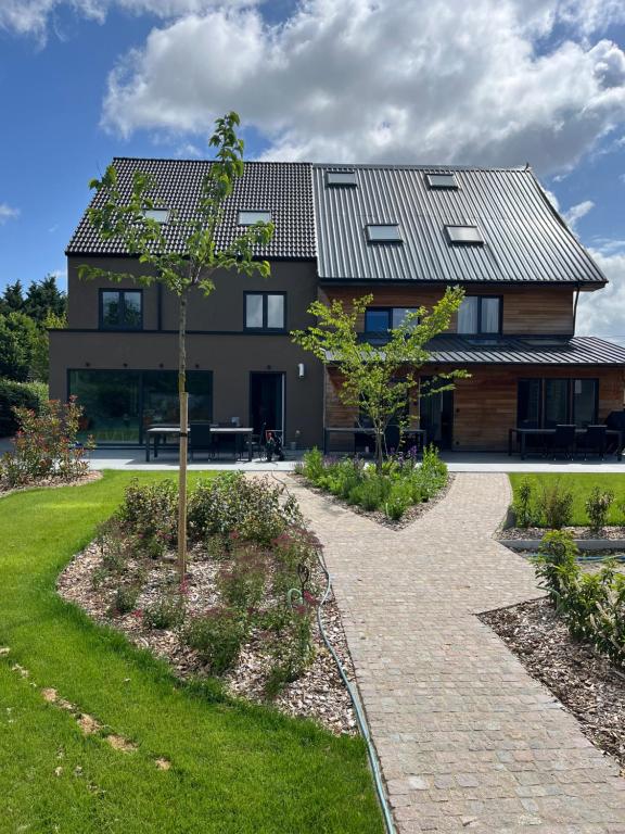 a house with a solar roof on top of it at Guesthouse Kriebeke in Tielt