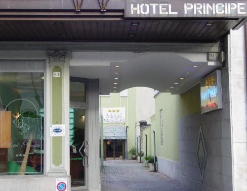 a hotel entrance with a sign on a building at Hotel Principe in Udine