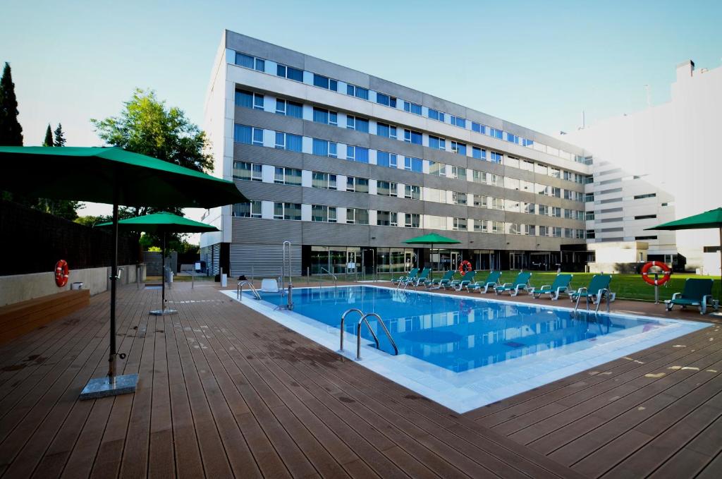 a large swimming pool in front of a building at Axor Feria in Madrid