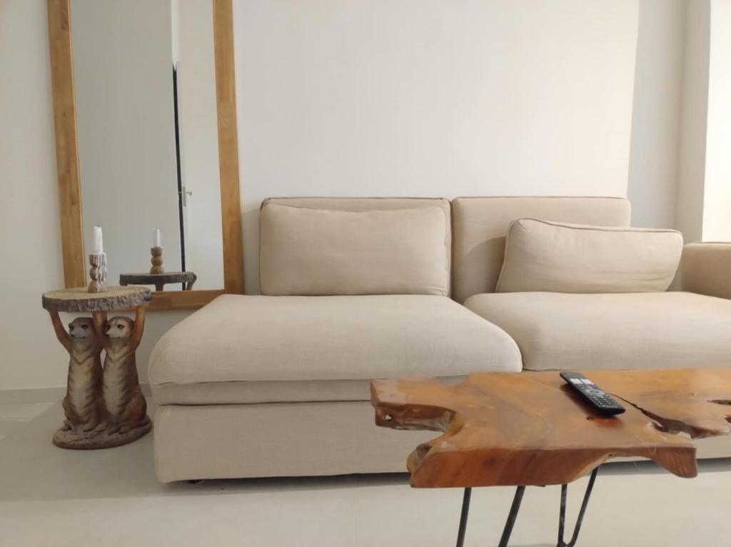 a living room with a white couch and a wooden table at Casa Medusa fun in Cullera