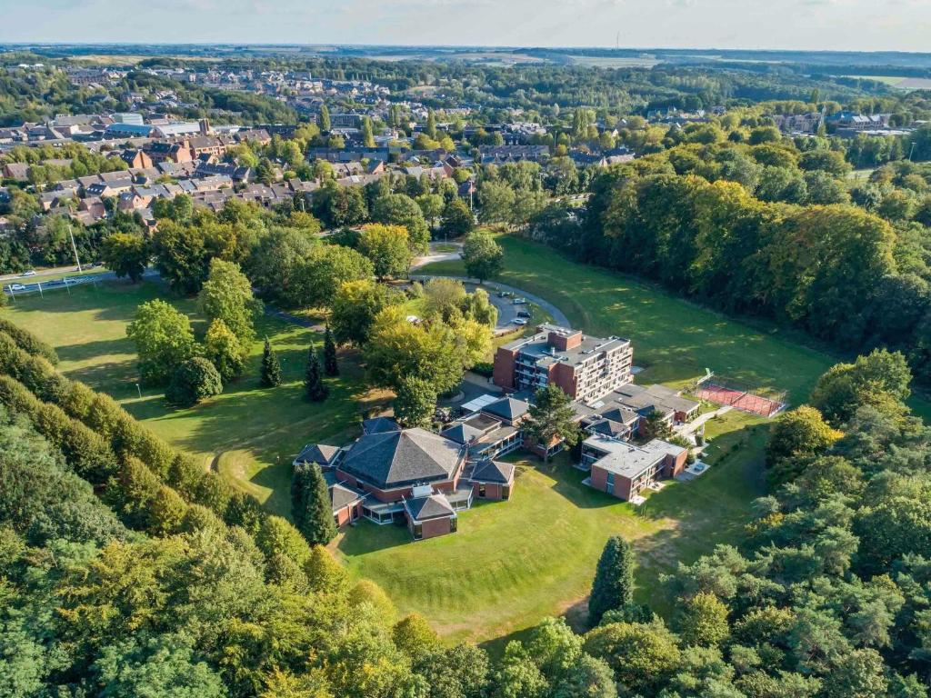 an aerial view of a large house on a green field at ibis Styles Louvain-la-Neuve Hotel and Events in Louvain-la-Neuve