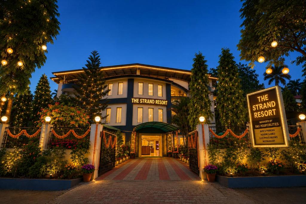 a large building with a sign in front of it at Strand Resort in Lonavala