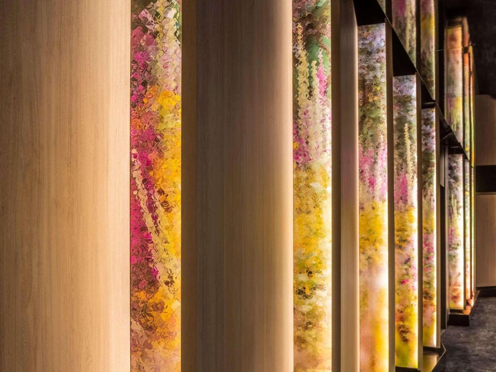 a row of books lined up on a wall at Pullman Melbourne City Centre in Melbourne