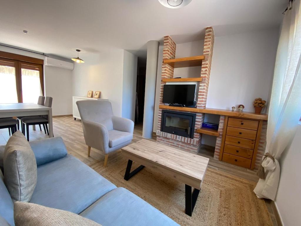 a living room with a blue couch and a table at R2R - Apartamentos Prellezo - C20C03 in Prellezo