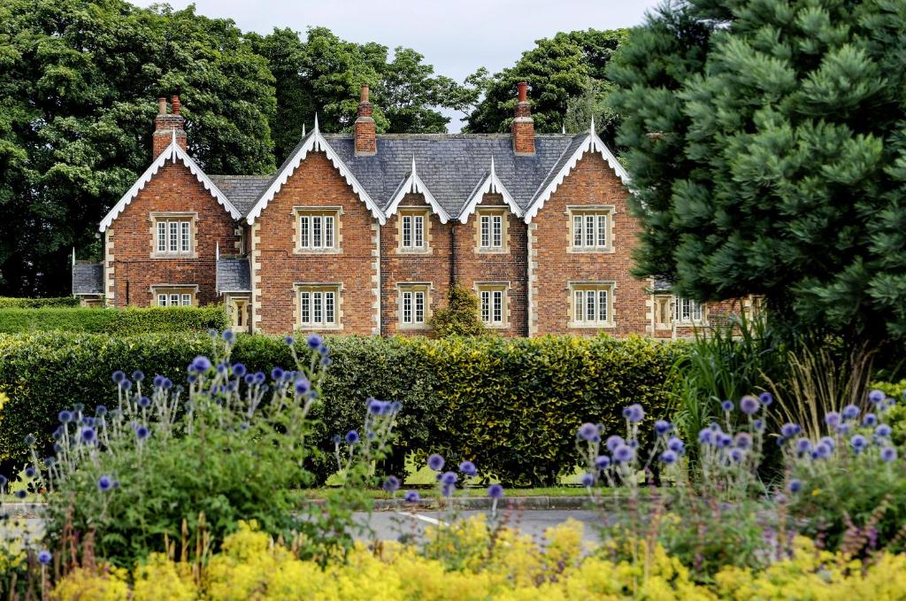 an old brick house with a garden in front of it at Mount Pleasant Hotel Self-Catering Cottages in Doncaster